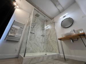 a bathroom with a shower with a sink and a mirror at Le Domaine des Songes in Saint-Maden +25 photos