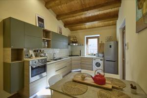 a kitchen with a table with a red tea kettle on it at Casa Vicolo TerminIO in Fermo