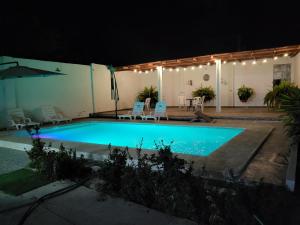 a swimming pool at night with lights on it at Casa de playa Iberico in Caleta Grau +1 photo