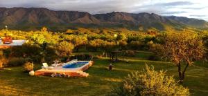 a backyard with a swimming pool and mountains in the background at La Emilia in Las Rabonas