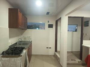 a kitchen with a sink and a stove top oven at Hotel Cartagena antigua in Cartagena de Indias