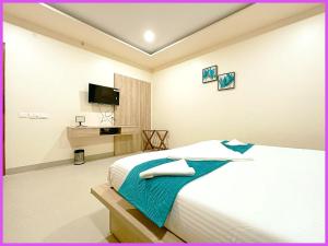 um quarto de hotel com uma cama e uma TV em SEA VIEW from rooftop AP INN Hotel - Restaurant And Lift - Air-Conditioned Rooms with Balconies - A sea view Luxuary Hotel em Puri