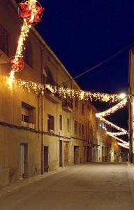 an empty street with christmas lights on a building at Casa de poble Cal Casellas in San Martín Sasgayolas