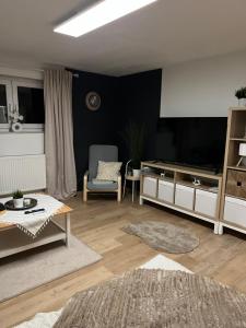 a living room with a large television and a couch at Ferienwohnung Zum Preußensteig in Pfeffelbach