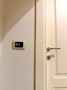 a white door with a clock on it at B&B Arco Trinità in Bari