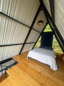 a bedroom in a tent with a bed in it at Ebenezer Chalet in San Antonio del Tequendama