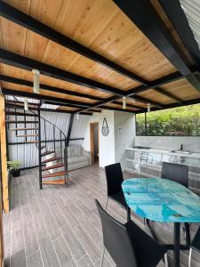 a patio with a table and chairs and a kitchen at Ebenezer Chalet in San Antonio del Tequendama