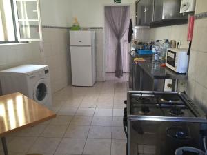 a small kitchen with a stove and a refrigerator at Asian Everest House in Lisbon