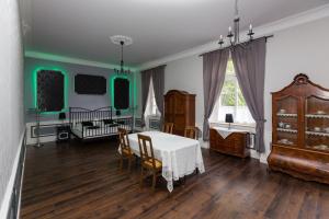a dining room with a table and a crib at Schloss Lohm in Lohm