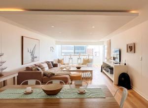 a living room with a couch and a table at Kana Vista in Plettenberg Bay