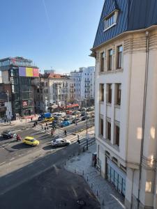 a view of a city street with cars and buildings at Studio Central Doamnei in Bucharest