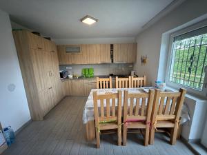 a kitchen with a table and chairs in a room at White Villa Blažuj in Blažuj