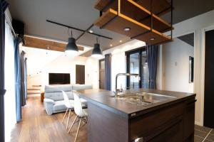 a kitchen with a sink and a living room at Casa Stay Kokura 1 - Vacation STAY 18791v in Kitakyushu