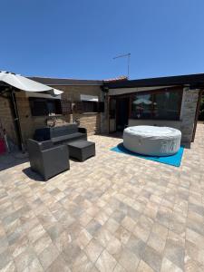 a patio with a fire pit and furniture on it at Private house with car park at nemi lake 