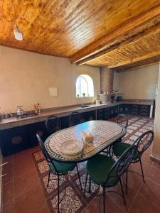 a table and chairs in a room with a kitchen at Your Peaceful Spot in Essaouira