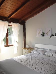 a bedroom with a white bed and a window at Private house with car park at nemi lake 