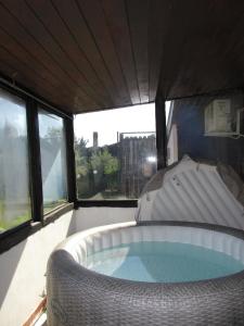 a large hot tub in a room with windows at Private house with car park at nemi lake 