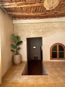 a hallway with a table and a potted plant at Your Peaceful Spot in Essaouira