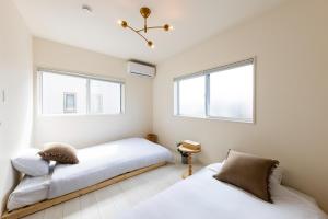 En eller flere senge i et værelse på HAJIME STAY KASUGA 4 - Vacation STAY 85892v