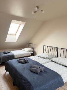 Mirabelka - domek في Podostrówek: غرفة نوم بها سريرين مع مناشف عليهما