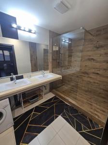 a bathroom with two sinks and a shower at Apartman Nina in Donovaly +23 photos