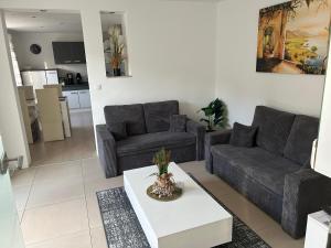 a living room with a couch and a table at Lenne-Blick Ferienwohnungen-Living Apartment in Finnentrop