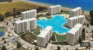 a model of a resort with buildings and a swimming pool at Departamento en Papudo laguna con acceso a la playa in Quinquimo +13 photos