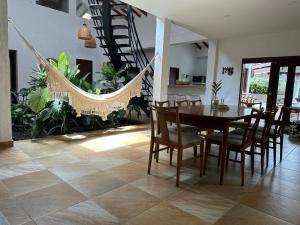 a dining room with a hammock and a table and chairs at Finca La Verbena in San Jerónimo
