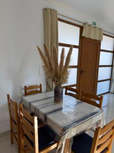 een eettafel met een vaas met een plant erop bij Cullura in Asklipiḯon +24 foto's