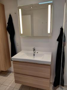 a bathroom with a sink and a mirror at Apartment in green area in Grindsted +26 photos