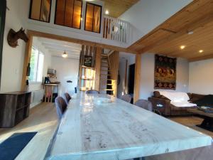 a large wooden table in a living room at Chalet Mustang Vallée in Laruns