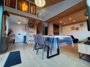 a dining room with a glass table and chairs at Chalet Mustang Vallée in Laruns +22 photos