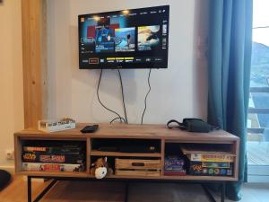 a tv sitting on top of a wooden entertainment center at Chalet Mustang Vallée in Laruns