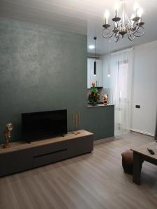 a living room with a flat screen tv and a couch at Elite Guest House in Goris
