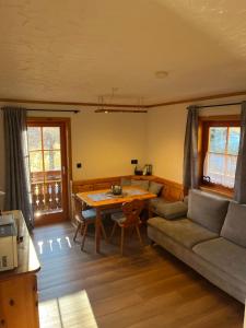 a living room with a couch and a table at Ferienwohnung Lahnerhof in Arriach