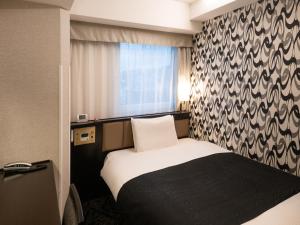 Postel nebo postele na pokoji v ubytování APA Hotel Asakusa Shin Okachimachi Ekimae