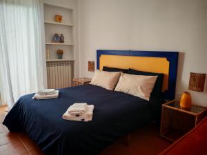 a bedroom with a blue bed with two towels on it at B&B Mareluce in Torre del Greco
