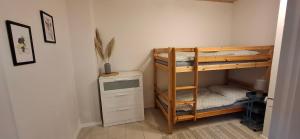 a room with two bunk beds and a desk at Ferienwohnung Thomas in Adenbach