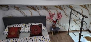 a bedroom with a bed and a vase with flowers at Lille Flandre duplex in Lille