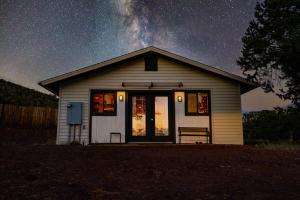 a small house with a starry sky behind it at Cozy Cub Cabin, Wilderness Retreat Williams AZ near Grand Canyon, Fire pit in Williams