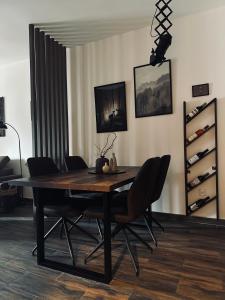 a dining room with a wooden table and chairs at Apartman Viktorija in Žabljak