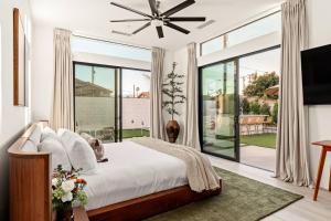 a bedroom with a bed and a large window at Desert Oasis: Pool, Spa, Golf Sim + EV Charger in Bermuda Dunes