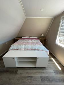 a bedroom with a bed in a attic at Departamento interior in Puerto Montt