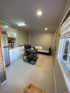 a kitchen and living room with a table and a couch at Departamento interior in Puerto Montt +14 photos