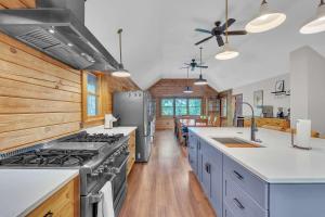 a kitchen with a stove and wooden walls at Gorgeous Lakefront Escape - New Renovations in Mineral