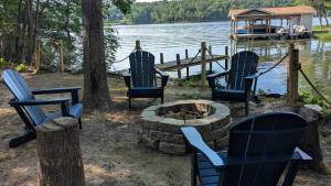 a group of chairs and a fire pit next to a lake at Gorgeous Lakefront Escape - New Renovations in Mineral