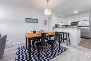 a kitchen with a table and chairs in a room at Beachfront Condo with Ocean Views and Pool Access in Croatan Shores