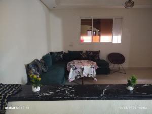 a living room with a couch and a table at Studio riad zitouna in Meknès +2 photos