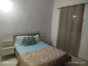 a small bedroom with a bed and a window at Studio riad zitouna in Meknès
