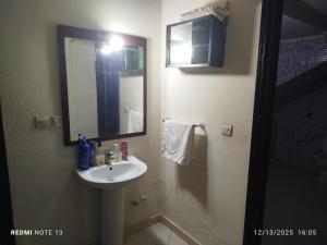 a bathroom with a sink and a mirror at Studio riad zitouna in Meknès